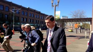 State Auditor Troy Kelley surrounded by media as he leaves the U.S. District Court after pleading not guilty to 10 counts. (Photo by Venice Buhain.)